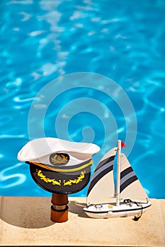 Marine cap on a telescope and ship next to the pool