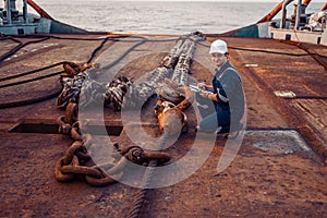 Marine chief officer or chief mate on deck of ship or vessel. He fills up ahts vessel checklist. Ship routine paperwork