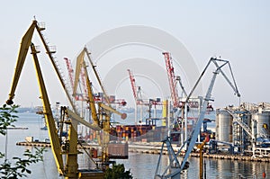 Marine container cranes in seaport of Odesa sky background