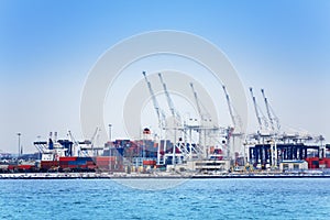 Marine cranes and containers at maritime port photo