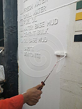 Marine crew painting hull