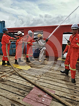 Marine  crews conduct fire drill on board ship