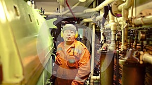 Marine engineer inspecting ship`s engine in engine control room