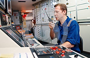 Marine engineer officer controlling vessel engines and propulsion in engine control room