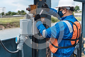 Marine engineering officer on the ship with protective mask Works on the ship with correct tools and equipment