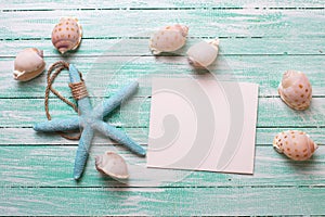 Marine items and empty tag on turquoise wooden background.