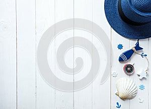 Marine items on wooden background. Sea objects: straw hat, swimsuit, fish, shells . flat lay, copy space. vacation and travel