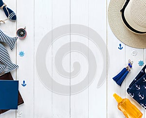 Marine items on wooden background. Sea objects: straw hat, swimsuit, fish, shells . flat lay, copy space. vacation and travel