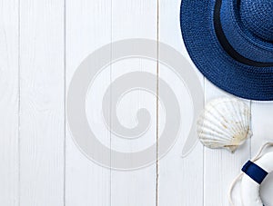 Marine items on wooden background. Sea objects: straw hat, swimsuit, fish, shells . flat lay, copy space. vacation and travel