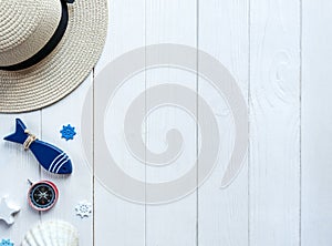 Marine items on wooden background. Sea objects: straw hat, swimsuit, fish, shells . flat lay, copy space. vacation and travel