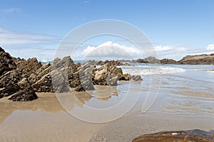 Marine landscape. Rocks and sea waves in a sunny day. Mangawhai Cliff Walk, New Zealand