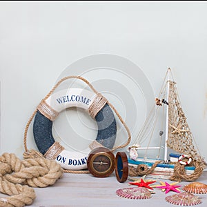 Marine life with starfish, boat, compass and seashells. Copy space on light background, retro toned