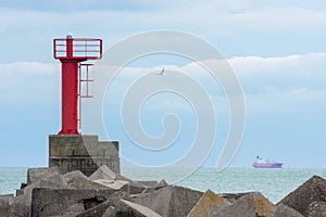 Marine lighthouse on the shore. Navigational signs. Escort of the ship to the port