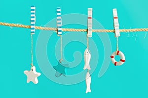 Marine or nautical themed background, summer sea toys lifeline, starfish and small fish hanging Bright summer style.