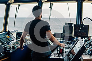 Marine navigational officer is maneuvering ship or vessel