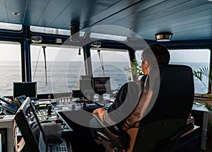 Marine navigational officer during navigational watch on Bridge . Work at sea