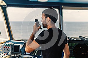 Marine navigational officer is reporting by VHF radio photo