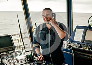 Marine navigational officer is reporting by VHF radio photo