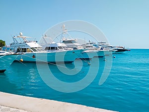 Marine parking of beautiful yachts and boats on clear calm water in Egypt. Travel and tourism concept.