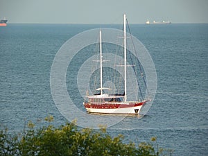 Marine pleasure yacht near the shore on the waves