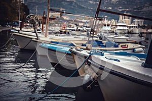 Marine port with moored yachts and boats in sea during sunset