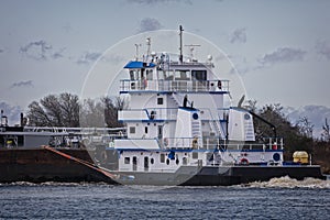 Marine push boat or tug boat in river with barge