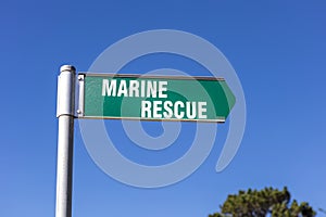 Marine Rescue sign attached to metal pole in a coastal town in Australia.