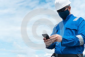 Marine seaman or bosun on deck of vessel or ship. He is speaking on the mobile cell phone