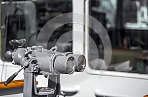 Marine stationary binoculars mounted on the deck of a ship