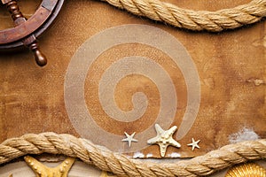 Marine symbols - hawser, ship`s steering wheel and seashells photo