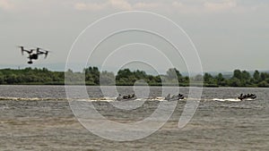 Marines, with weapons in their hands, move on military boats on the river