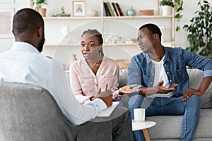 Marital Therapy. Irritated Black Woman Explaining To Counselor Relationship Problems With Husband