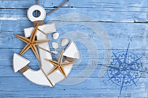 Maritime Decoration with shells, starfish, sailing ship, fishing net on blue drift wood