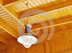 Maritime hanging lamp at a wooden ceiling