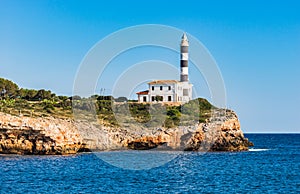 Maritime lighthouse at cliffs of Porto Colom on Majorca, Spain