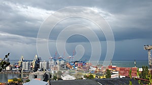 Maritime port landscape with cargo loaders and cloudscape above