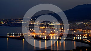 Maritime port of Malaga Spain at night with the city of Malaga in the background