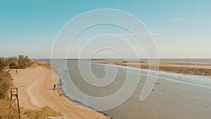 Mariupol fishermen manually collect shellfish on the shore. city in peacetime.