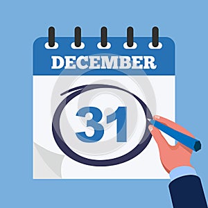 Mark on the calendar at 31 december. Close-up businessman hand with calendar and blue marker.