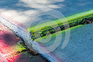 Marked sidewalk trip and fall hazard on uneven concrete slab walkway requires inspection and repair to prevent accident legal