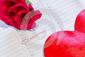 Marked the Valentine`s day on calendar with rose and heart