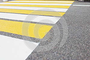 Marked white and yellow walkway across road or street