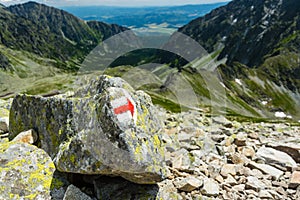 Marker with correct direction on high mountain trail below Koprovsky peak