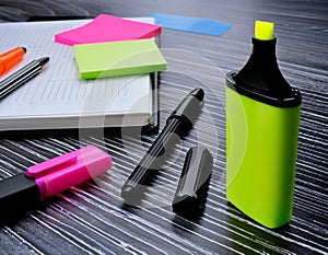 Marker and writing tools featuring elements like pens, highlighters, and written notes representing writing, annotation, and photo