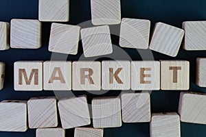 Market, buy and sell place in modern internet world concept, straggle cube wooden blocks with some combine the word Market with photo