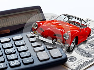Market car concept. Red vintage Toy car calculator and 100 money dollars bills or banknotes