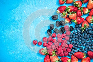 Market fresh mixed berry fruits, top view, border background