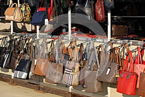 Market for handbags and purses on the street. Imitation of brand bags. Fake branded ladies hand