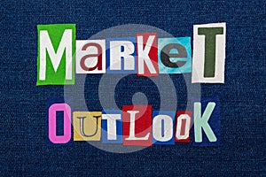 MARKET OUTLOOK text word collage, multi colored fabric on blue denim, future market direction concept