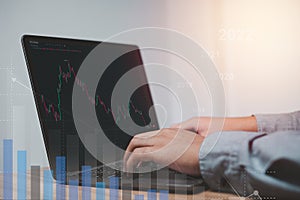 Market planning, stock market investing when hoping to make a profit A businessman uses a laptop to analyze stocks.